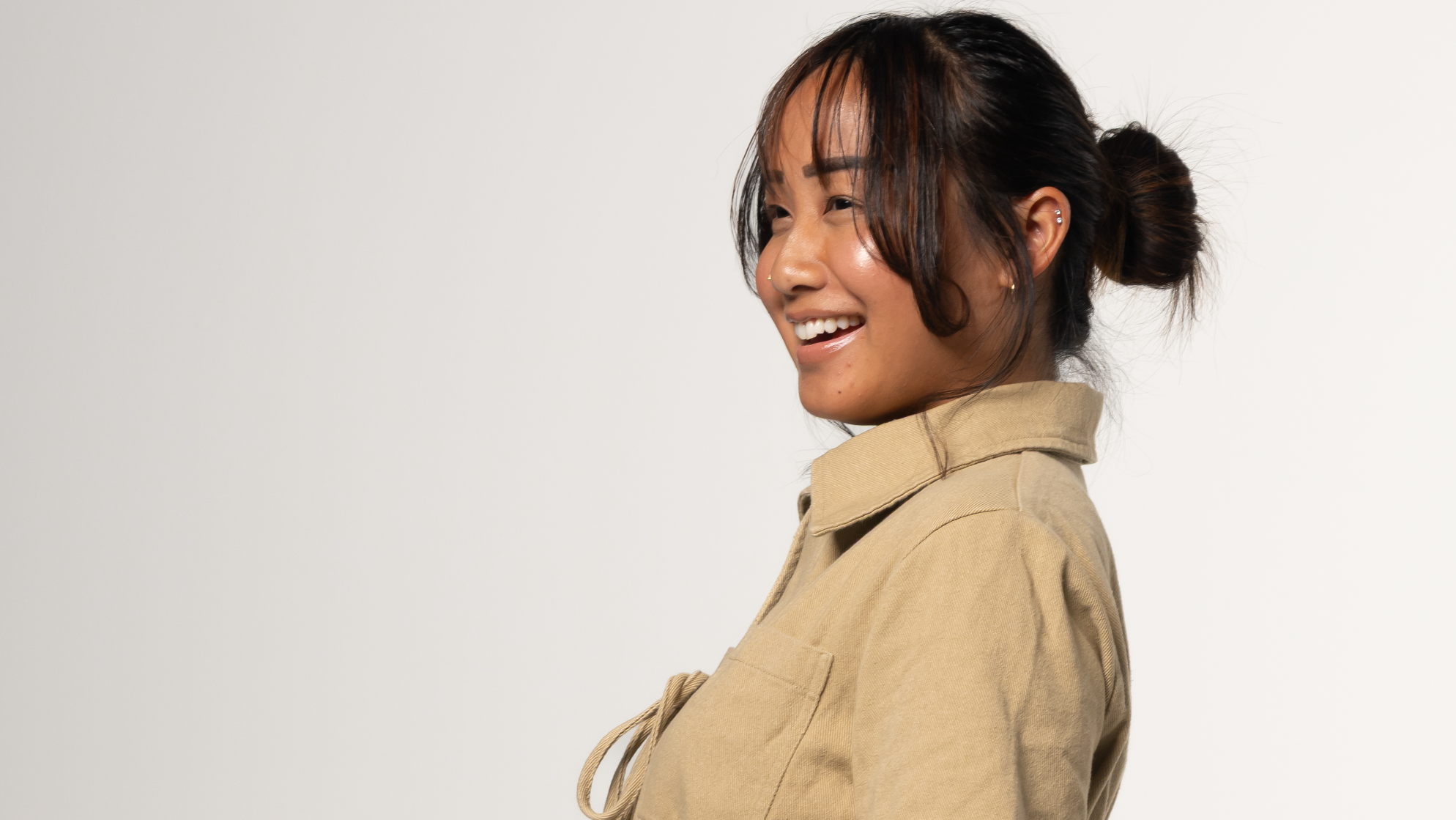 Woman wearing a beige romper on a white background